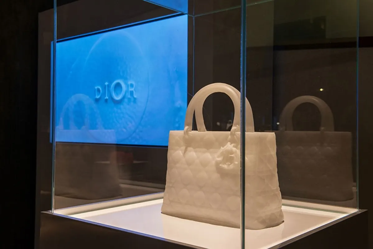 The wax Lady Dior sculpture displayed alongside the film, presenting object and documentation as a single work.