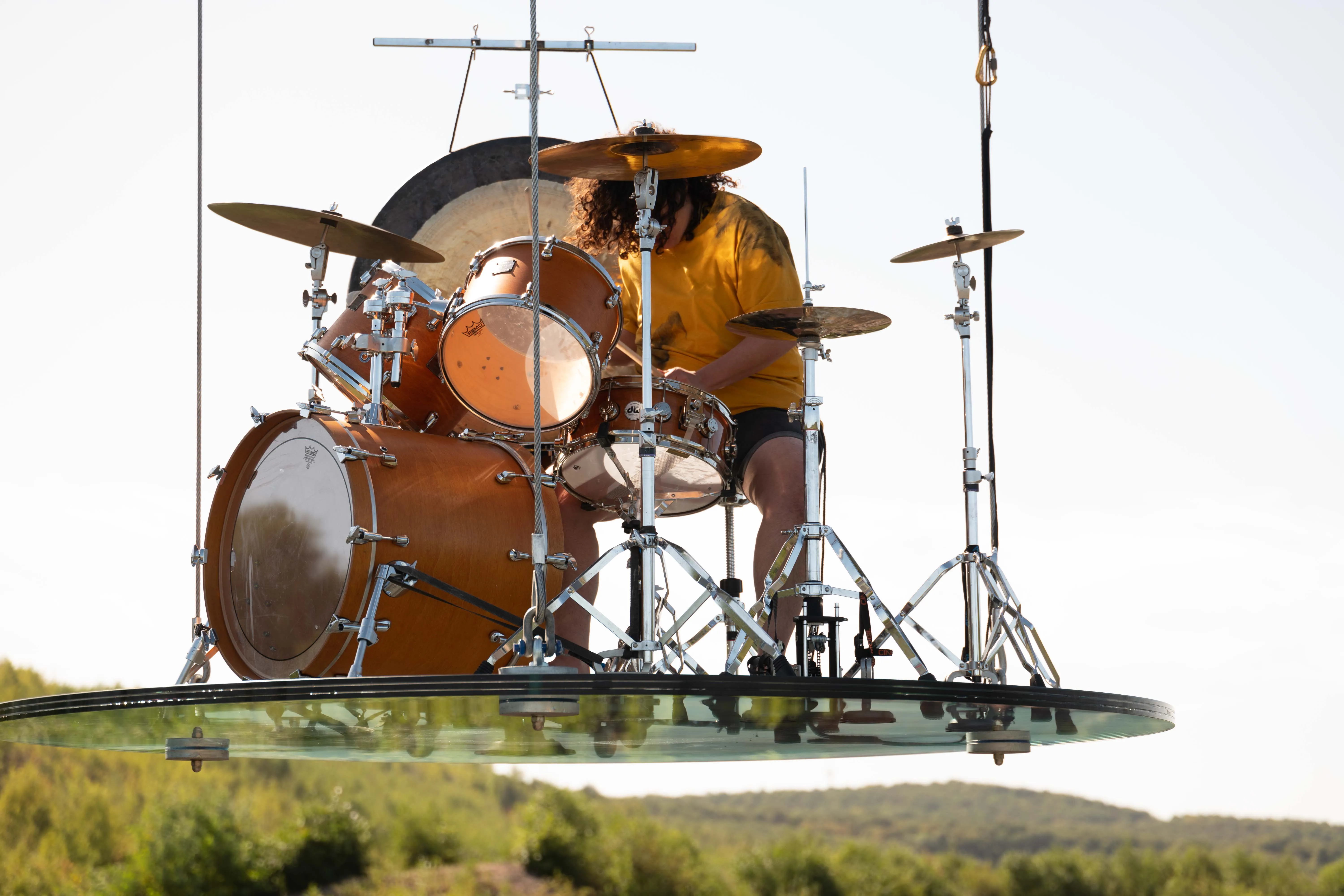 Alejandra Levi performing suspended above the landscape.